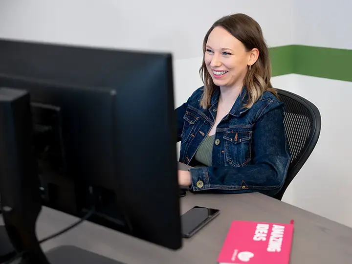 Woman looking at screen and smiling
